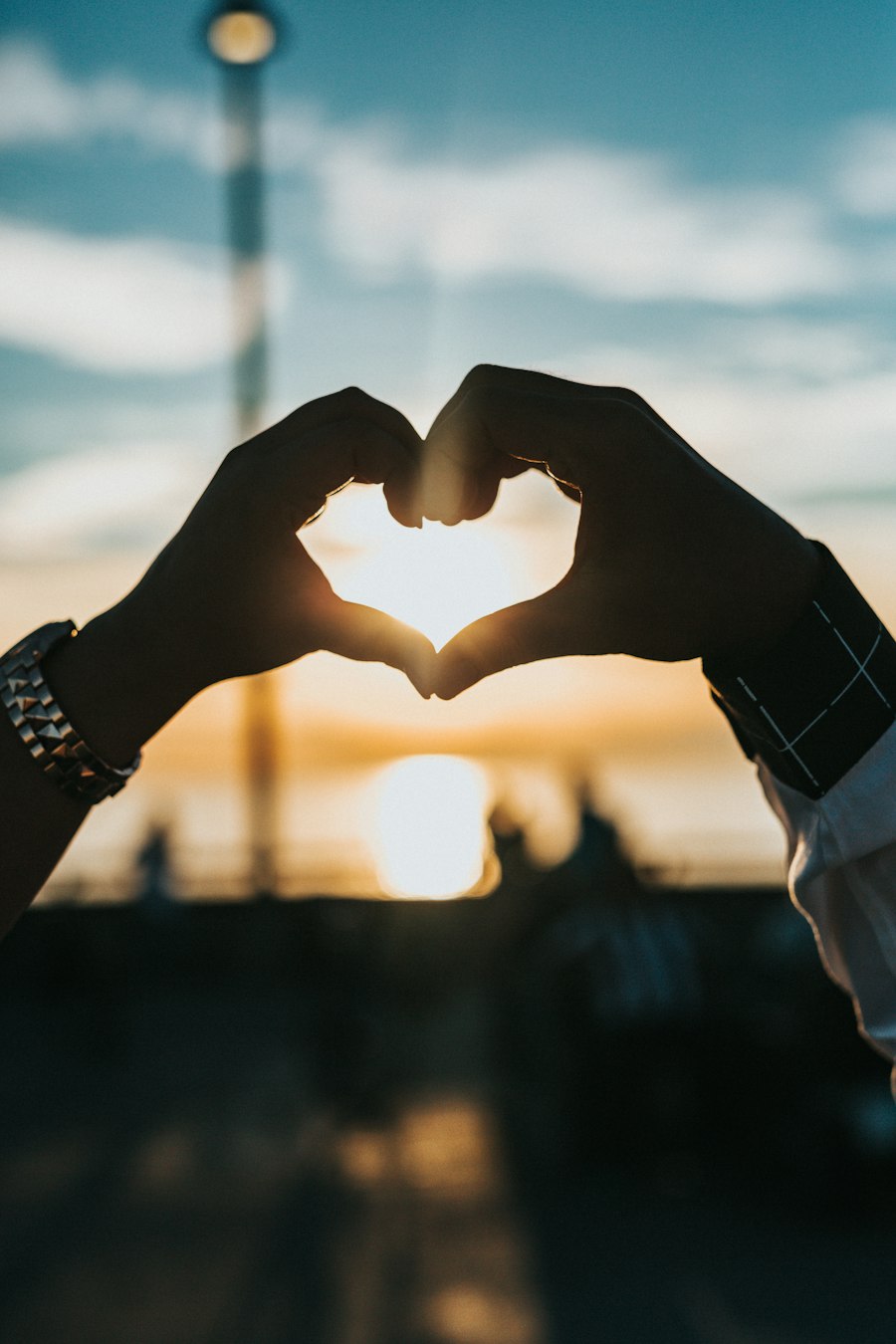 Couple in love holding hands at sunset - WhatLovers